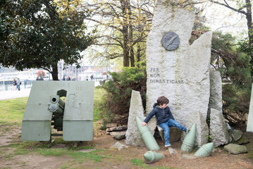 Child explores military monument in urban park