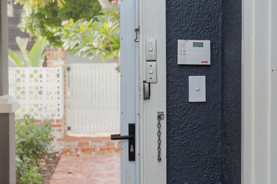 Looking out of house through security door, with alarm system visible