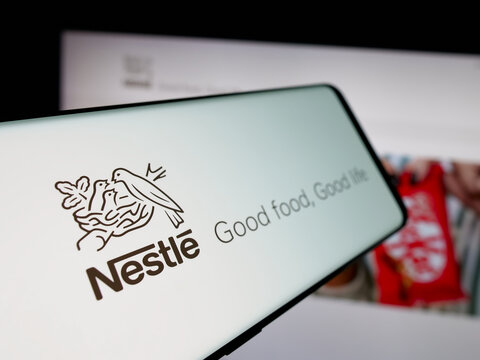 Stuttgart, Germany - 04-09-2025: Smartphone with logo of Swiss food and beverage company Nestle S.A. on screen in front of website. Focus on left of phone display.