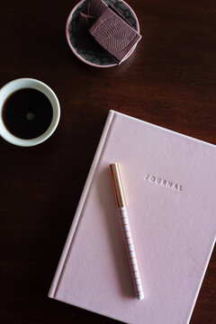 journal book with chocolate and coffee