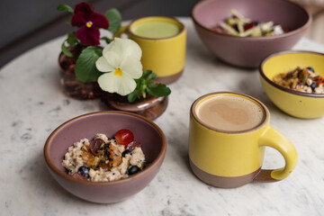 Fresh fruit muesli and drinks on marble table