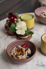 Fresh fruit muesli and drinks on marble table