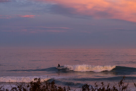 Sunset surf session off coast of Kaikoura, New Zealand