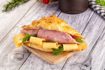 Fresh croissant with ham and cheese