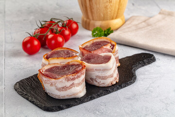 Raw pork tenferloin with bacon