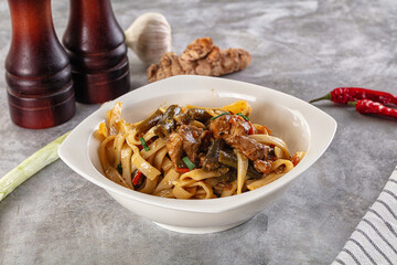 Asian cuisine udon with chicken and vegetables