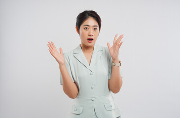 Surprised woman in business attire with hands up showcasing a state of shock or disbelief