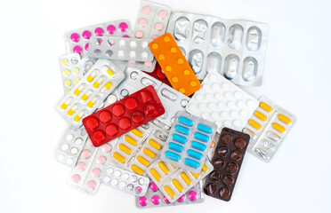 Various tablets and capsules on the table. Selective focus.