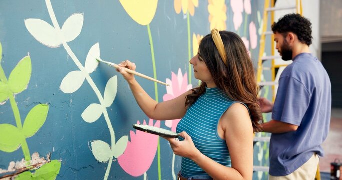 People, creative and painting in city for wall art, mural and project to uplift community. Volunteer, team creativity and outdoor with equipment for floral design, designer collaboration or DIY hobby