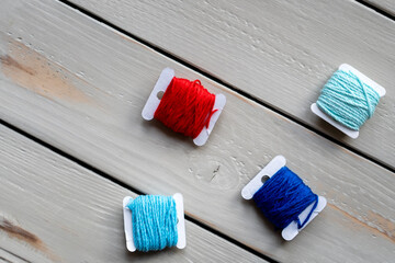 Handicraft threads remain on the wooden surface