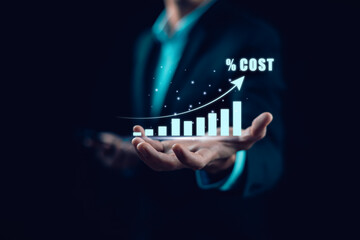 Businessman holding virtual cost growth chart with upward arrow. Concept of rising expenses,...