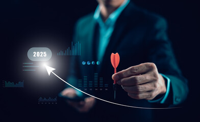 Marketing strategy concept for 2025. Businessman holding dart, targeting future goals with data...