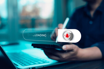 Businessman using digital tablet with loading bar and notification alert icon. Concept of...