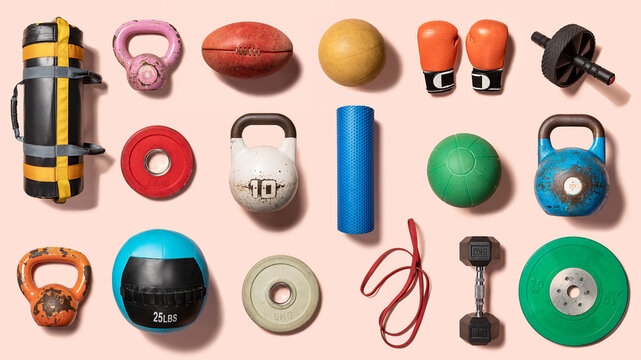 Flatlay of sporting and gym equipment on a pink background