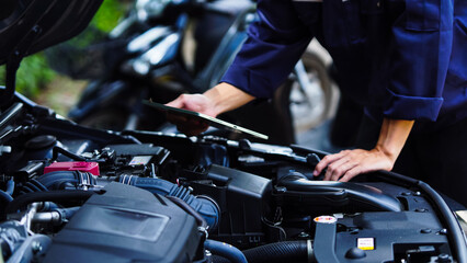 Auto mechanic hands using wrench to repair auto engine. Car maintenance, service at garage....