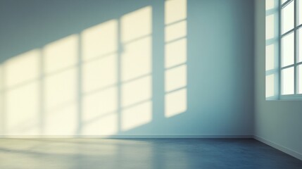 Fototapeta premium Empty room with sunlight casting shadows on a wall