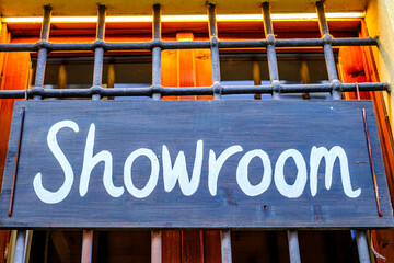 Sign for a showroom with a wooden frame and metal grille, capturing the essence of a unique...