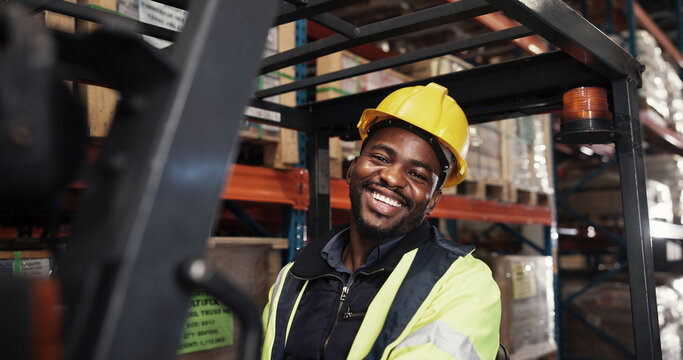 Warehouse, portrait and black man with forklift for logistics, supply chain or shipping for distribution. Factory, male person or worker with machine for driving, delivery or manufacturing with smile - Powered by Adobe