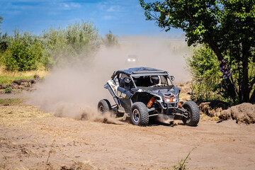 UTV buggy moves on dusty road. 4x4, extreme, adrenalin. © Antonio