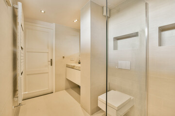 A sleek, contemporary bathroom features minimalist design elements, elegant fixtures, and neutral tones, creating a serene and stylish atmosphere.