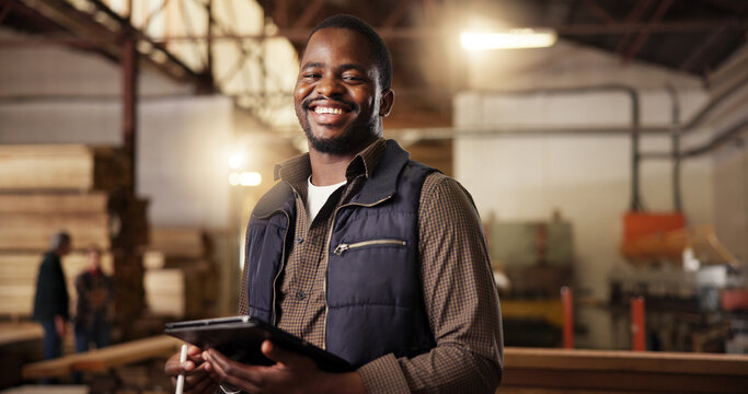 Portrait, happy carpenter and man with tablet in workshop for furniture manufacturing and inventory. Woodwork, smile and person with technology at industrial factory for joinery, carpentry and design