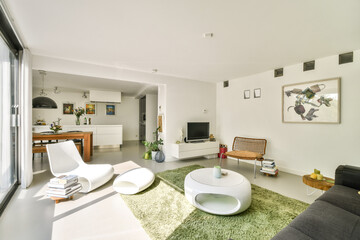 A sleek, contemporary living room featuring minimalist furniture, a cozy atmosphere, and vibrant touches from decor elements. The space feels airy and inviting.