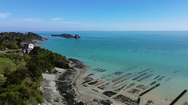 aerial shot of cancale with a vieeew on a field of oysters