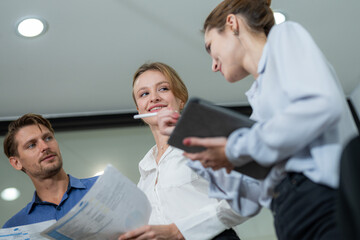 Group of professionals discussing project details in a modern office during a meeting