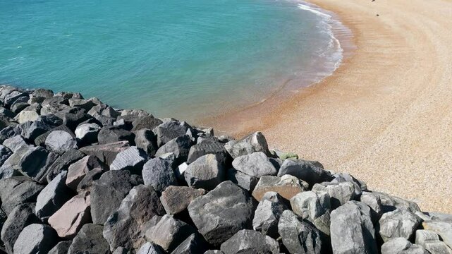 Drone Flight Over Folkestone Beach Rocks in April Sunshine