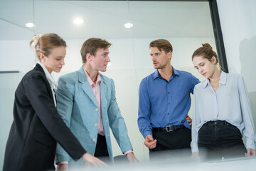 Team members engage in discussion during a meeting in a modern office space