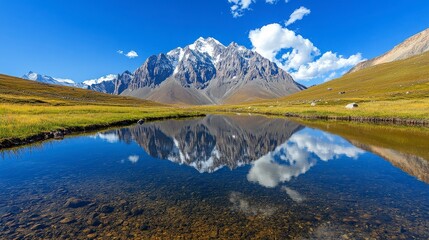 Fototapeta premium Majestic Mountain Range Reflected in Tranquil Lake Under Blue Sky
