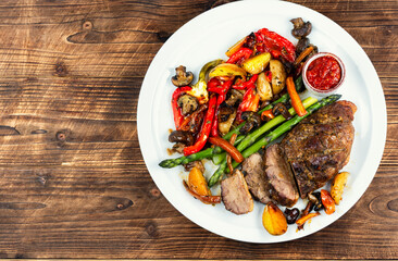 Delicious fried duck breast on wooden surface.