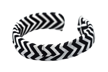 Stylish black and white chevron patterned hairband resting on a plain surface, showcasing modern accessory design and elegance isolated on transparent background