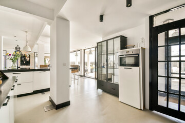 A stylish modern kitchen featuring sleek cabinetry, bright lighting, and open space, creating a welcoming atmosphere for cooking and dining.