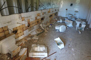 Destroyed Bathroom in Abandoned School with Broken Fixtures
