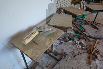 Abandoned Classroom with Broken Desks and Scattered Debris