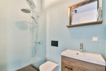 A sleek modern bathroom featuring a stylish shower, minimalist cabinetry, and calming color palette, creating a serene atmosphere for relaxation and hygiene.