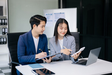 Portrait of success business people working together in office. Couple teamwork startup concept.