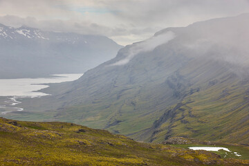 Foggy mountain landscape in Berufjordur fjord. East fjords. Iceland