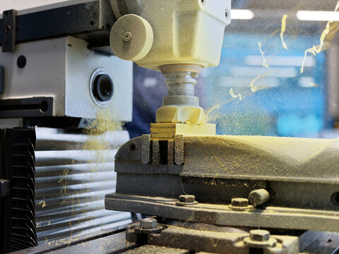 CNC machine cutting wood block at factory