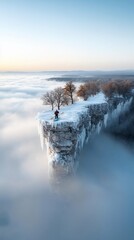 Solitary hiker on a snowy clifftop, above a sea of clouds