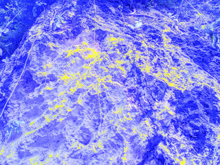 Abstract digital rendering of a textured surface in vibrant blue and yellow, showcasing intricate patterns and depth.