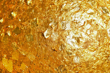 Gold leaf sheets on rock ball