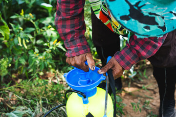 Spraying pesticides to protect crops agriculture field action shot outdoor close-up sustainable...