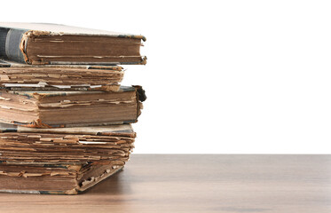 Old books on wooden table against white background