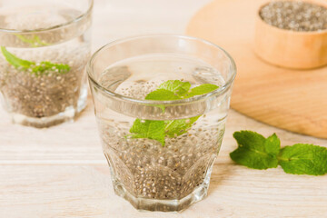 Healthy breakfast or morning with chia seeds and mint on table background, vegetarian food, diet and health concept. Chia pudding with and mint