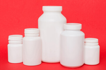 supplement pills with medicine bottle health care and medical top view. Vitamin tablets. Top view mockup bottle for pills and vitamins with green leaves, natural organic bio supplement, copy space
