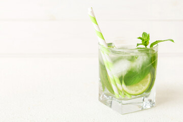 Mojito cocktail. Refreshing mojito cocktail with lime, lemon and mint in a tall glass with a stick