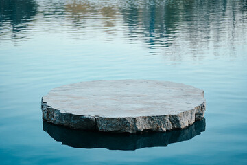 Stone platform floating on calm blue water tranquil scene peaceful nature