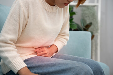 stomach ache. Asian women have abdominal pain, indigestion, gastritis, menstrual cramps,...